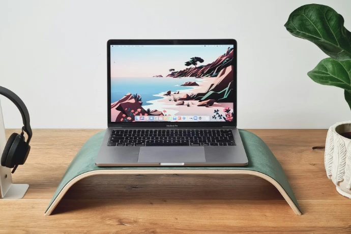 a laptop computer sitting on top of a wooden desk